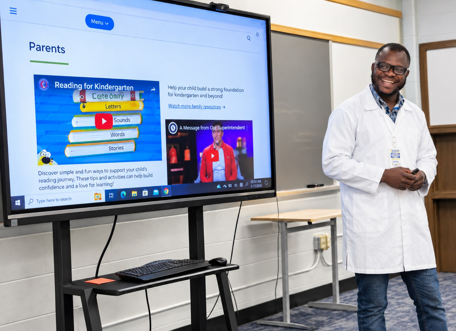 Teacher presenting a school parent portal on an interactive display