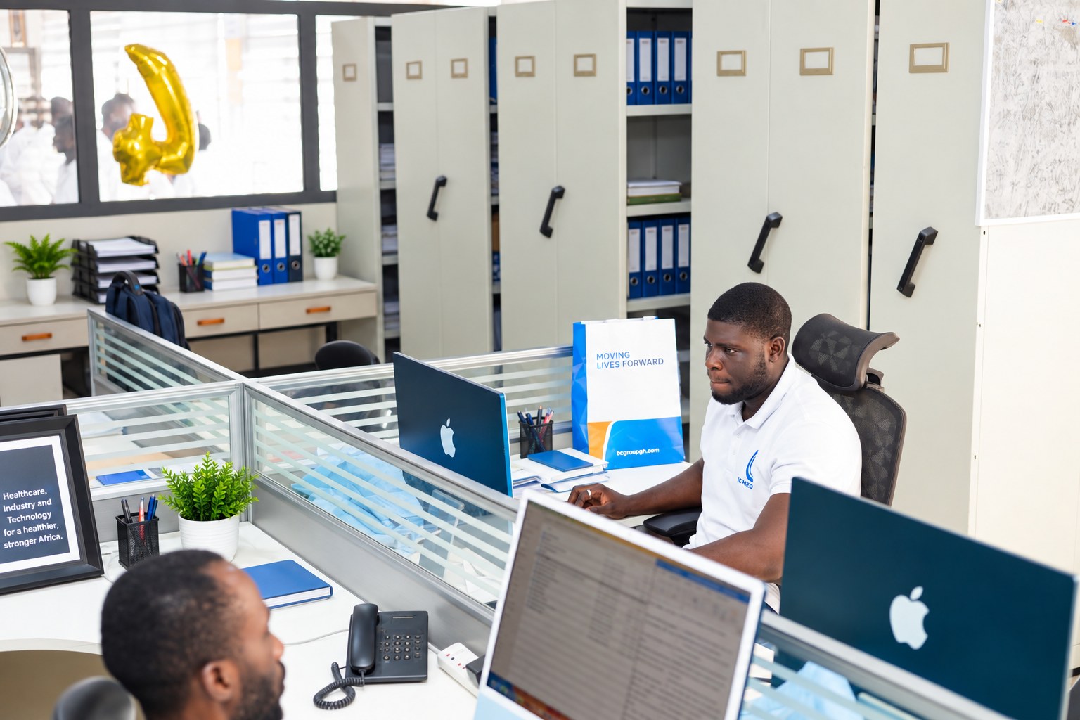 BC team members working at connected workstations in the group offices