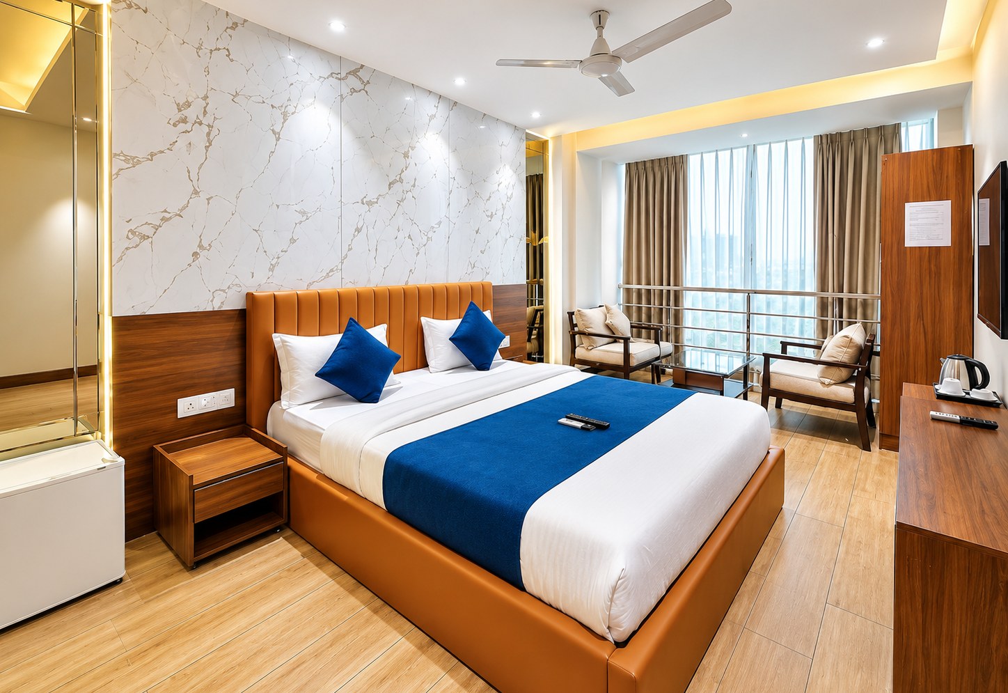 Furnished hotel guest room with seating area and work desk