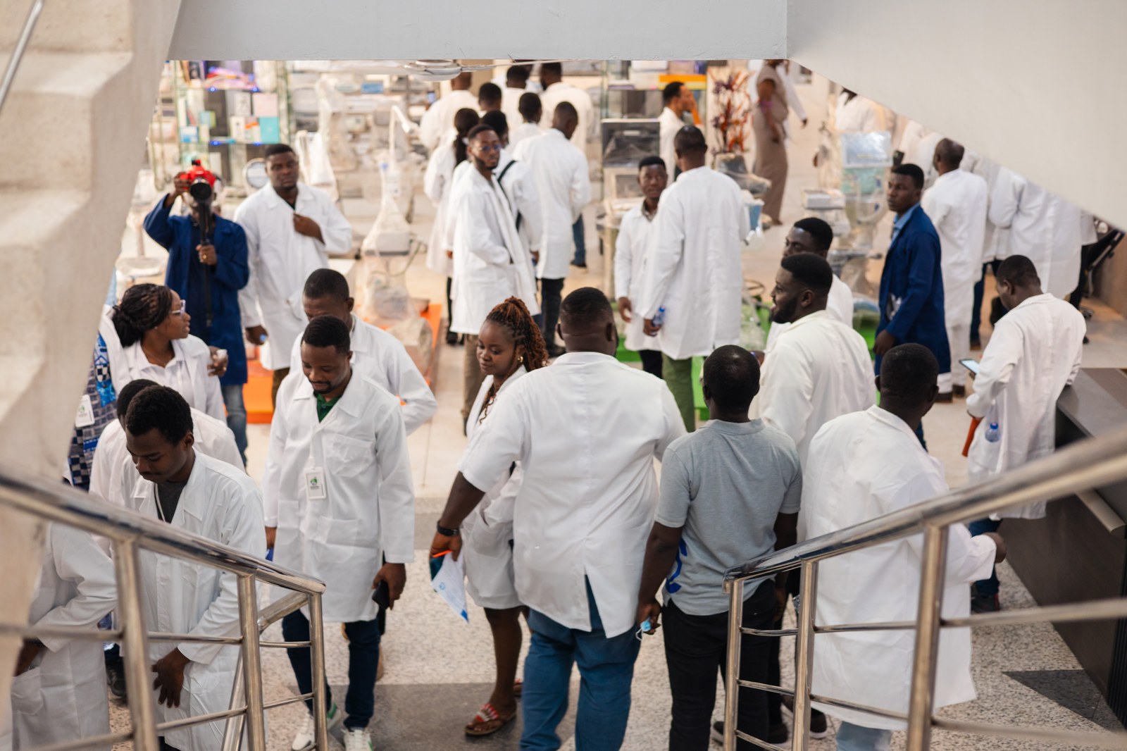 Engineers in lab coats during a facility tour at Beautiful Creations Limited.